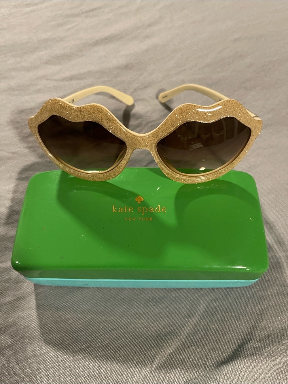 kate spade gold glitter lip-shaped sunglasses with brown lenses